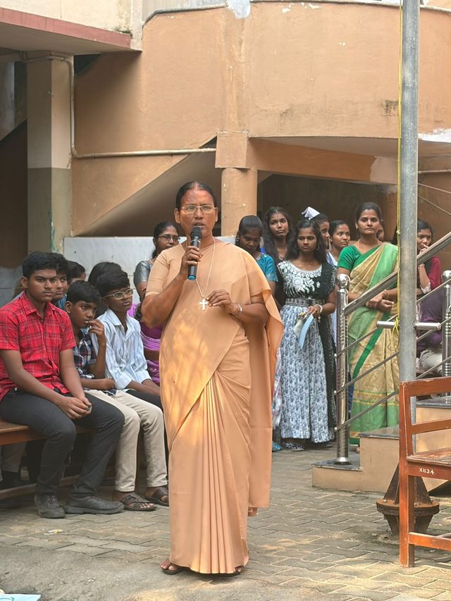 A teacher speaking at the assembly