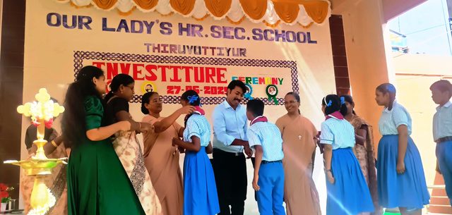 Lighting the lamp at the Investiture Ceremony